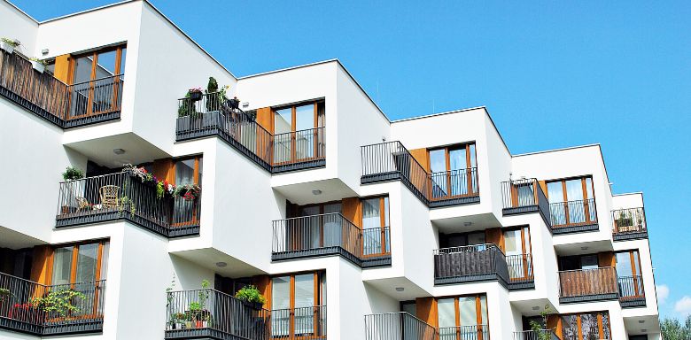 A white, cubic apartment building.