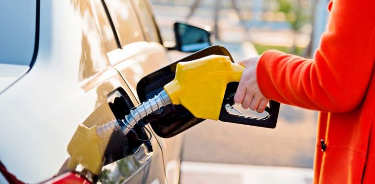 A person pumping gas into a car.