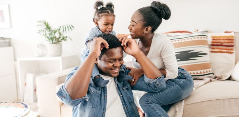 Two parents playing with their young child.
